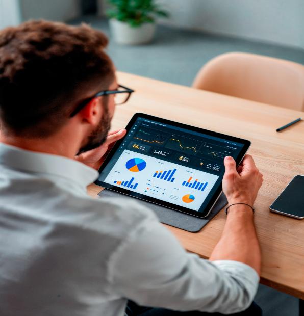 man is looking tablet that has graph graph it 1